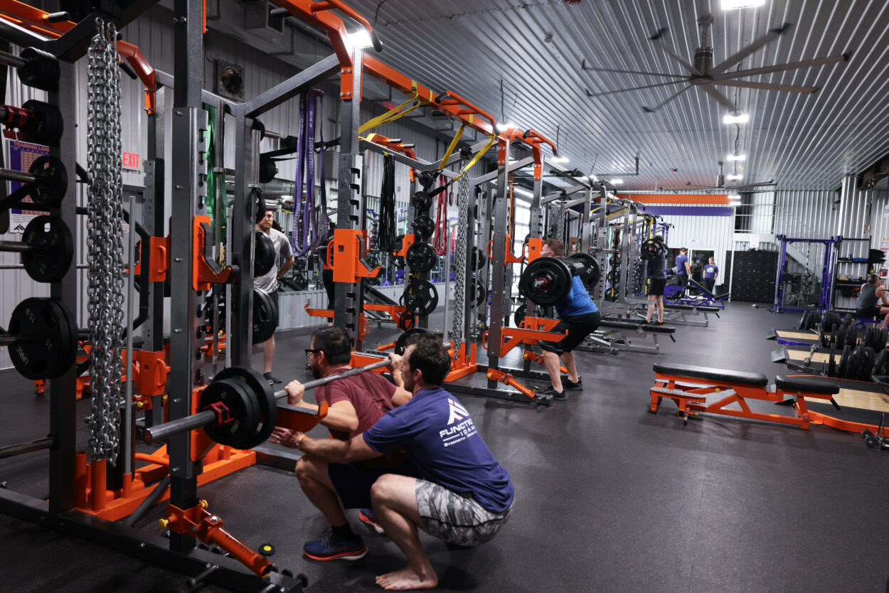 Marshall Weber spotting a partner during a Faith and Fitness class at Functional Idaho in Boise, Idaho