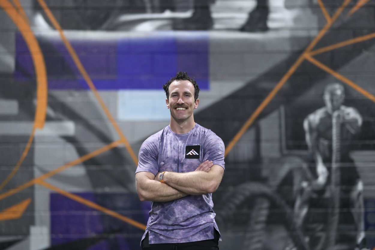 Marshall Weber standing inside Functional Idaho gym with arms crossed, representing the connection between faith, fitness, and whole-body wellness.