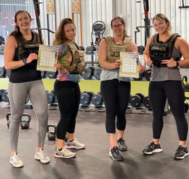 Women posing for a picture during a HIIT Class